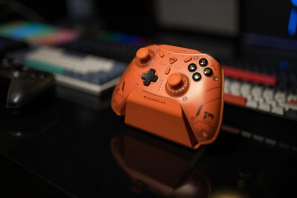 https://www.pexels.com/photo/vibrant-orange-gaming-controller-on-desk-32755790/